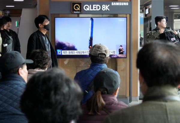 People are seen watching a news broadcast of North Korea's missile launch at the Seoul Railway Station in Seoul, South Korea, on Feb. 14, 2024.