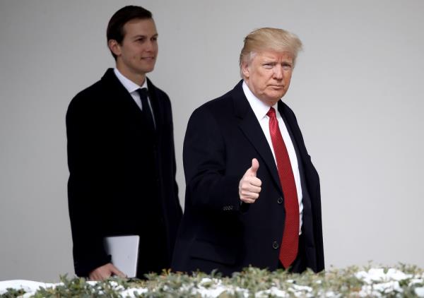 President Trump giving a thumbs up sign while walking with Jared Kushner  at the White House in Washington, DC.