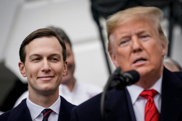 Jared Kushner smiles as Do<em></em>nald Trump speaks into a microphone