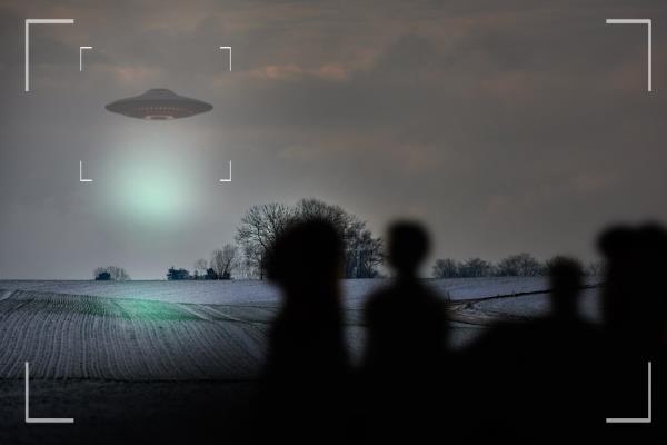 UFO, alien and camcorder on a camera display to record a flying saucer