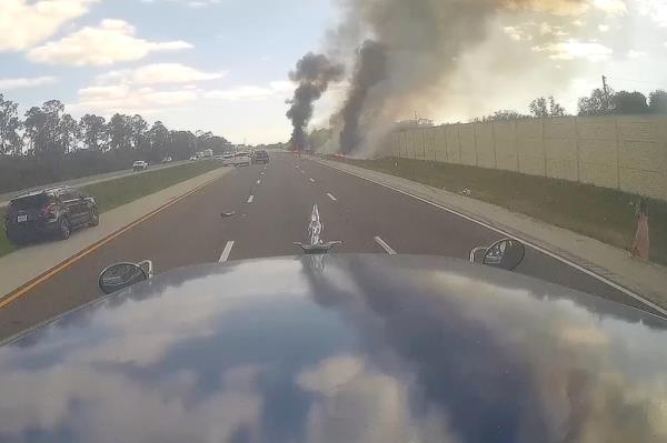 Plane burning along highway