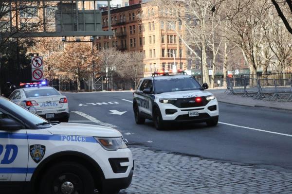 NYPD vehicles parked on the side of the Manhattan Bridge entrance at Canal Street after protest shut down tunnels.