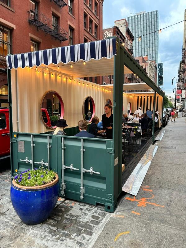 Diners seated inside pen-air dining shed at Lure Fishbar